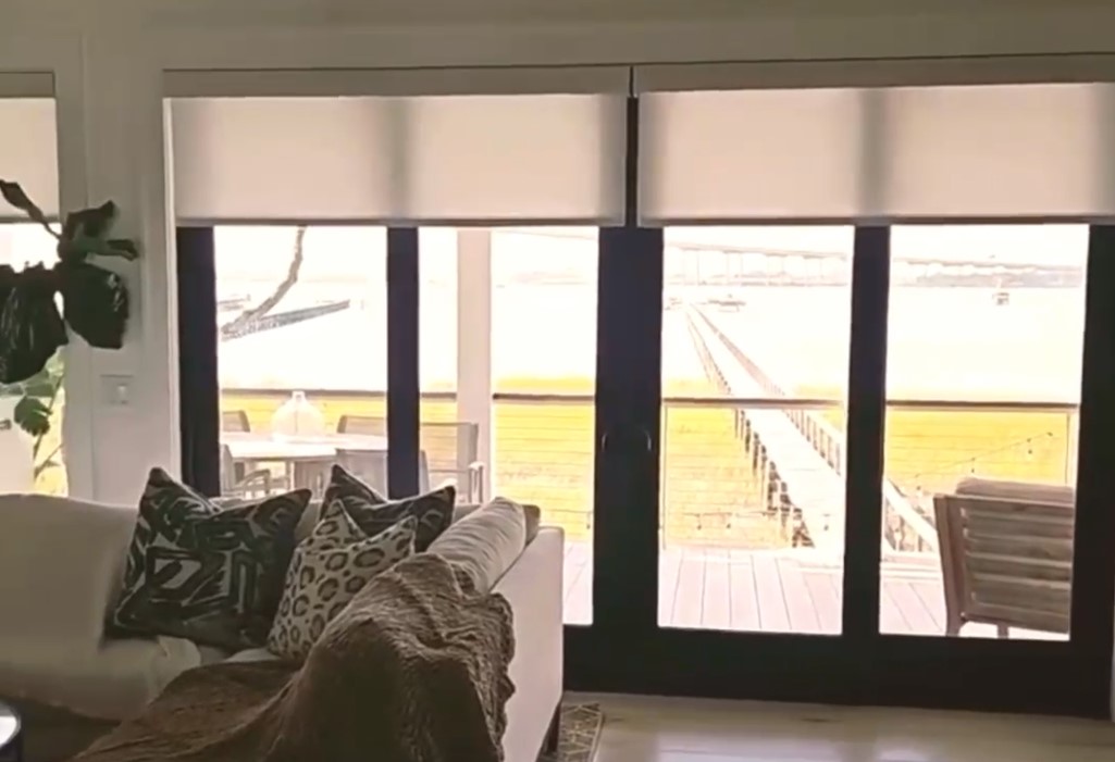 sheer shades being lowered using motorization in home